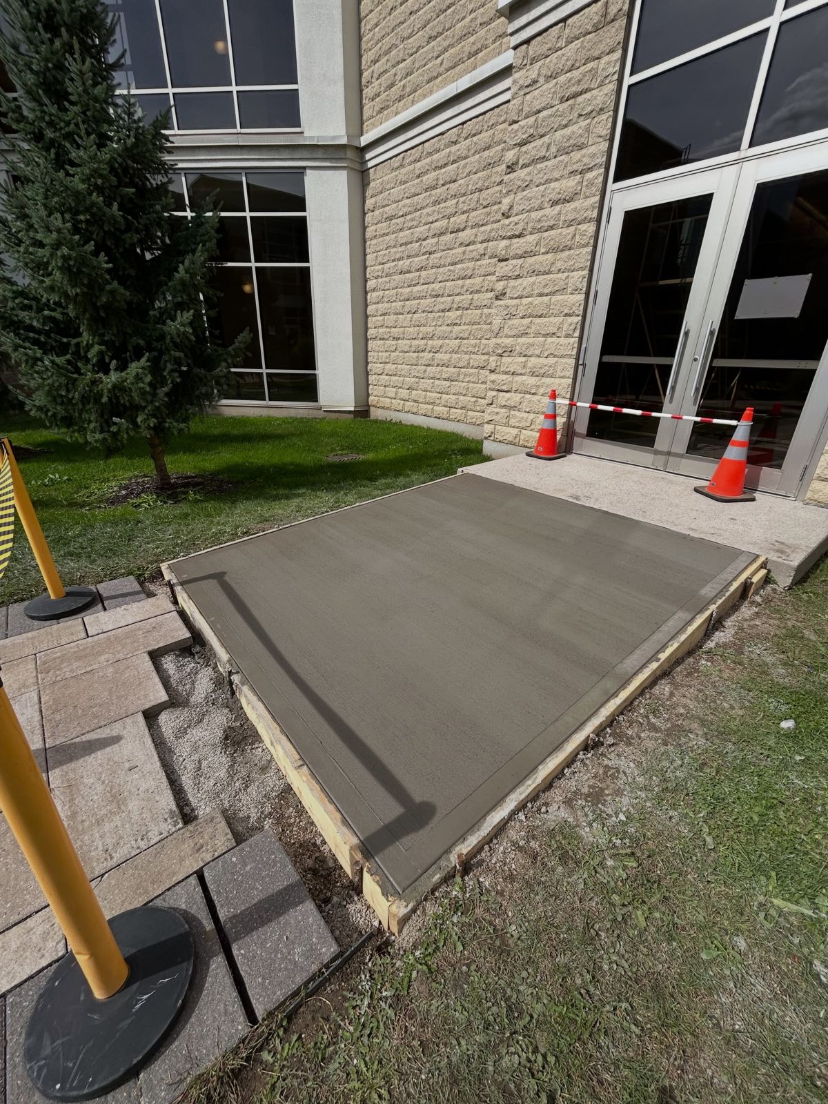Fresh concrete pad poured and finished inside its forms